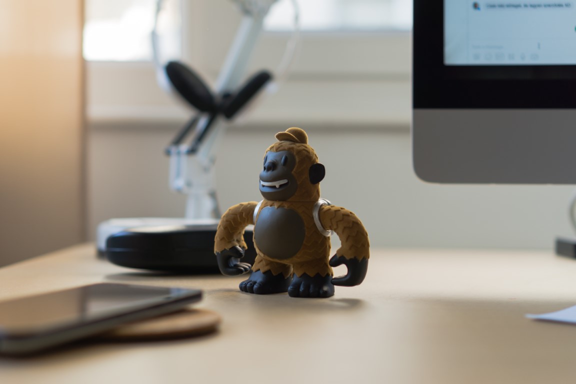 a toy monkey on a desk